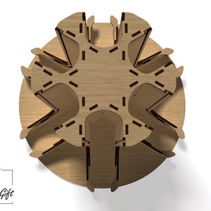 May include: Top view of a wooden, circular, multi-tiered stand with a starburst design. The stand has six tiers and is made of light brown wood.