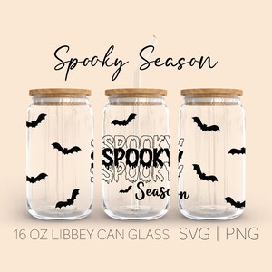 May include: Three 16 ounce glass jars with wooden lids and black bats printed on the sides. The middle jar has the text "Spooky Season" printed on it in a dripping font.