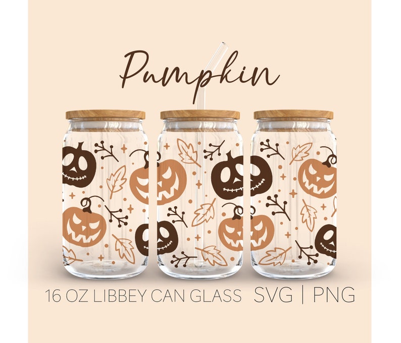 May include: Three 16 ounce glass jars with lids and straws. The jars are decorated with a pattern of orange and brown pumpkins, leaves, and stars. The text "Pumpkin" is written in brown cursive at the top of the image.