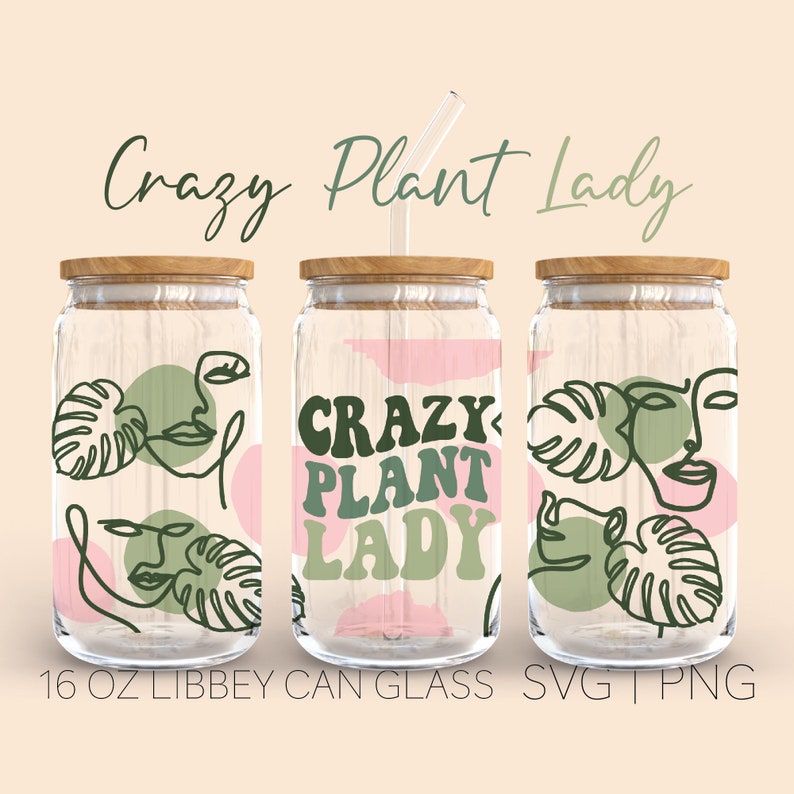 May include: Three 16 ounce glass jars with wooden lids and green straws. The jars are decorated with a pink and green pattern of abstract faces, leaves, and the text "Crazy Plant Lady".