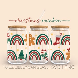 May include: Three 16 ounce glass jars with wooden lids and a Christmas rainbow design. The design features red and green rainbows, candy canes, gingerbread people, Christmas trees, and stockings.