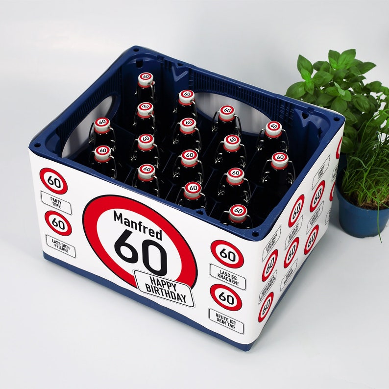 May include: A blue and white cardboard crate with a red and white speed limit sign that says "Manfred 60" and "Happy Birthday". The crate is decorated with smaller speed limit signs that say "60" and various phrases in German.