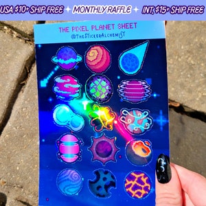 May include: A sheet of holographic stickers featuring pixel art of planets in various colors and designs. The sheet is blue with the text "THE PIXEL PLANET SHEET" and "@THESTICKERALCHEMIST" printed on it.
