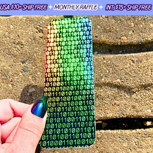 May include: A rainbow-colored bookmark with a pattern of 0s and 1s. The bookmark is made of a durable material and is perfect for marking your place in a book.