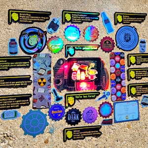 May include: A collection of colorful stickers with various designs and text. The stickers feature images of bottles, bottle caps, and retro-style graphics. Some stickers have text like "Nuka Cola", "You've lost farma!", and "Idolized".