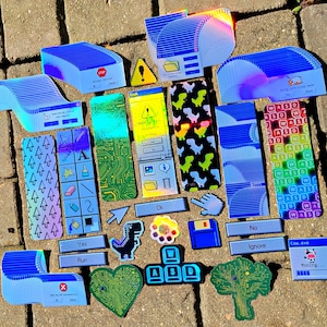May include: A collection of colorful, holographic stickers featuring various retro computer-themed designs. The stickers include a dinosaur, a keyboard, a tree, a heart, a mouse pointer, a floppy disk, a folder, a window with the text "Cow.eve Mooing...", and a window with the text "Access Denied".