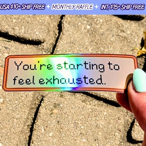 May include: A holographic sticker with a pixelated design and the text "You're starting to feel exhausted." The sticker is on a cracked concrete surface.