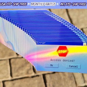 May include: A stack of iridescent holographic stickers featuring a blue and white Windows error message with the text "Error", "Access denied!" and "STOP" in red. The stickers have a blue border and a red stop sign icon.