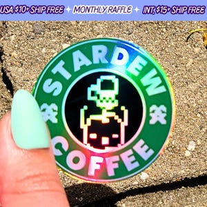 May include: A holographic sticker with a green background and a black circle in the center. The circle features a pixelated character from the video game Stardew Valley. The text "Stardew Coffee" is written around the circle in a rainbow font.