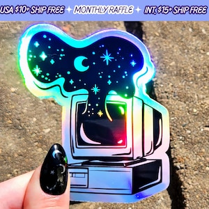 May include: A holographic sticker featuring a retro computer with a blue, black, and white color scheme. The computer is emitting a cloud of stars and a crescent moon.