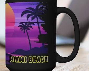 May include: Black ceramic mug with a sunset scene and palm trees. The text "Miami Beach" is printed in yellow on the mug.