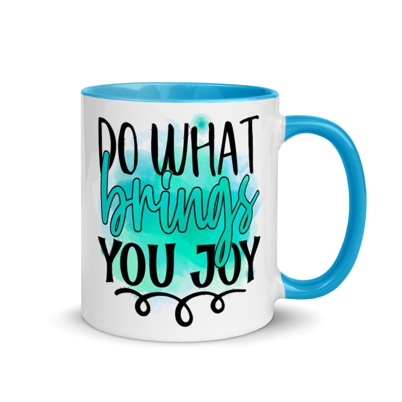 May include: White ceramic mug with a blue rim and handle. The mug features a teal watercolor design with the text "Do what brings you joy" in black lettering.