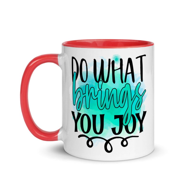 May include: White ceramic coffee mug with a red rim. The mug has a teal watercolor background with the text "Do what brings you joy" in black.