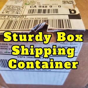 May include: A brown cardboard box with a white label that says "Sturdy Box Shipping Container" and has a USPS tracking number. The label also says "USPS DELIVER TO: STEVEN SCOTT 767 LUANKINI ST #4 LAHAINA, HI 967" and "PARCEL SELECT US POSTAGE PAID".