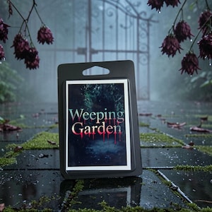 May include: A rectangular black plastic display card featuring a centred graphic print with the text Weeping Garden in a stylised font. The image depicts a dark, moody forest scene with deep green tones and red accents dripping from the letters.