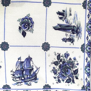 May include: White fabric with a blue and green floral pattern. The fabric features a repeating pattern of flowers, ships, and a checkered background.