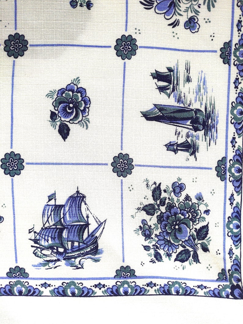 May include: White fabric with a blue and green floral pattern. The fabric features a repeating pattern of flowers, ships, and a checkered background.