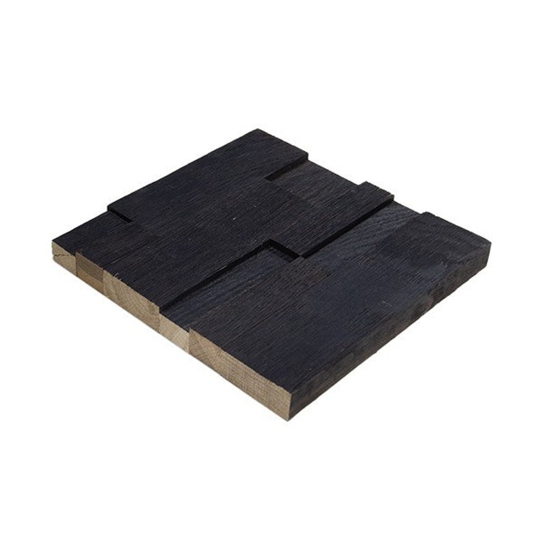 May include: A black wood wall panel with a unique interlocking design. The panel is made of reclaimed wood and has a rustic, industrial look.