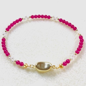 May include: A set of three ceramic mugs with a speckled, matte finish. The mugs are in shades of cream, light gray, and dark gray. Each mug has a simple, minimalist design, perfect for coffee or tea.