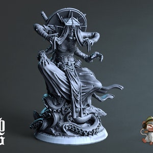 May include: A gray, detailed miniature figurine of a female figure with multiple arms and a headdress. The figure is seated on a base with an octopus design.