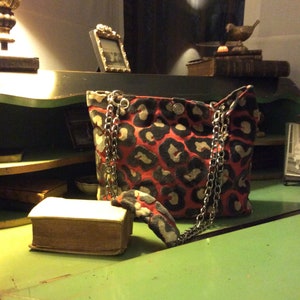 Red and black velvet bag with metal chain handle