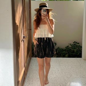 model wearing boho black and white tie-dye shorts on vacation