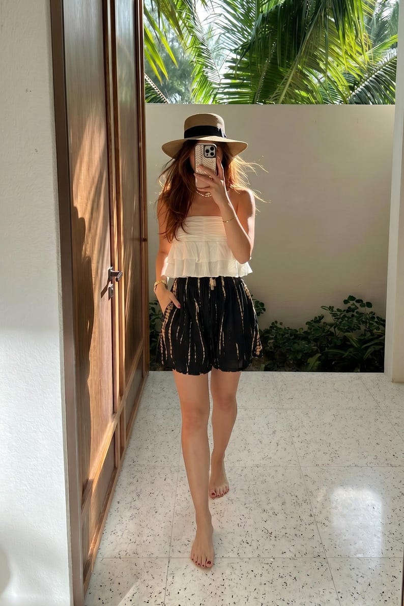 model wearing boho black and white tie-dye shorts on vacation