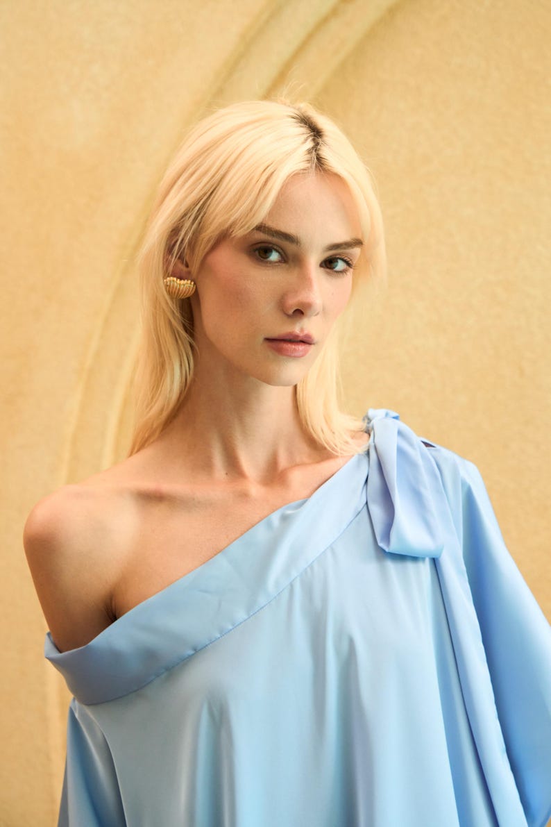 Handmade blue kaftan maxi dress with off shoulder styling, loose flowy fit, and self-tie bow detail, perfect for resort wear or a beach wedding guest outfit.