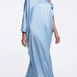 Handmade blue kaftan maxi dress with off shoulder styling, loose flowy fit, and self-tie bow detail, perfect for resort wear or a beach wedding guest outfit.