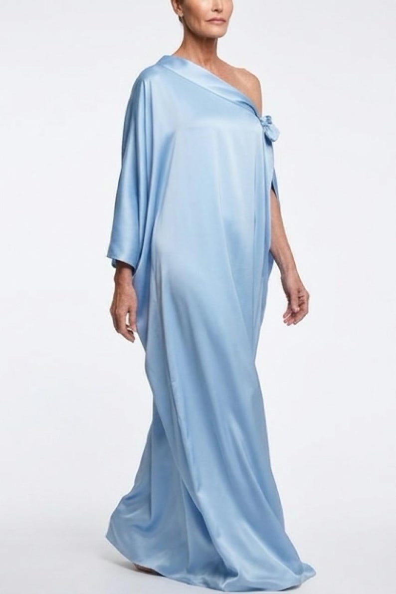 Handmade blue kaftan maxi dress with off shoulder styling, loose flowy fit, and self-tie bow detail, perfect for resort wear or a beach wedding guest outfit.