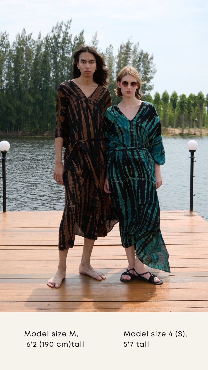 May include: Two models wearing long, tie-dye patterned dresses. The dress on the left is brown and black, while the dress on the right is teal and black. The model on the left is 6'2" (190 cm) tall and the model on the right is 5'7" tall.