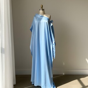 Handmade blue kaftan maxi dress with off shoulder styling, loose flowy fit, and self-tie bow detail, perfect for resort wear or a beach wedding guest outfit.