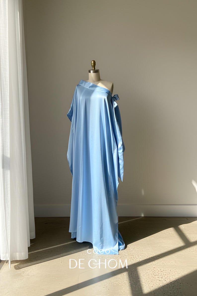 Handmade blue kaftan maxi dress with off shoulder styling, loose flowy fit, and self-tie bow detail, perfect for resort wear or a beach wedding guest outfit.