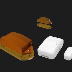 May include: A collection of electronic components. There's a large, brown and gold piece, a smaller brown and gold piece, and two white rectangular devices. The white devices have the word "onvis" printed on them.