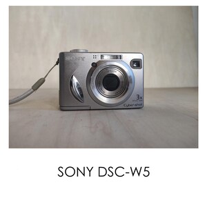 May include: A silver Sony Cyber-shot DSC-W5 digital camera with a 3x optical zoom lens.