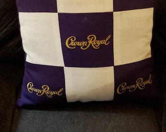 May include: A white and purple checkered pillow with the words "Crown Royal" embroidered in gold on each square.