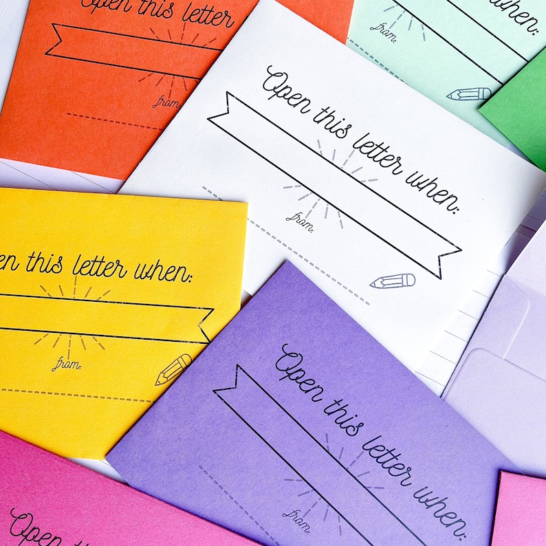 May include: A set of colorful envelopes with the text "Open this letter when:" printed on each one. The envelopes are in various colors, including orange, yellow, purple, and green.