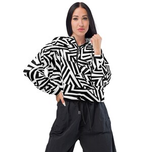 May include: A cropped jacket with a black and white geometric print and a zip fastening. The jacket has a relaxed fit and long sleeves.