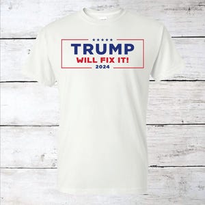 May include: White t-shirt with a red and blue rectangle graphic that says "TRUMP WILL FIX IT! 2024".