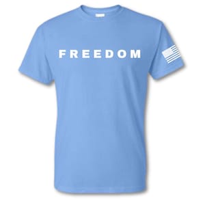 May include: A light blue t-shirt with the word "FREEDOM" printed in white across the chest. A small white and blue American flag is on the left sleeve.