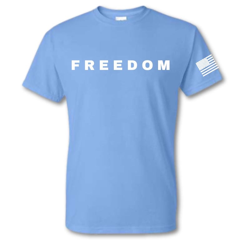 May include: A light blue t-shirt with the word "FREEDOM" printed in white across the chest. A small white and blue American flag is on the left sleeve.