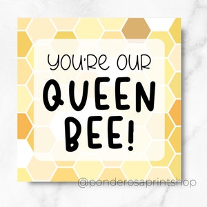 May include: A yellow and white honeycomb pattern background with a white rectangle in the center. The rectangle contains the text "You're our Queen Bee!" in black text.
