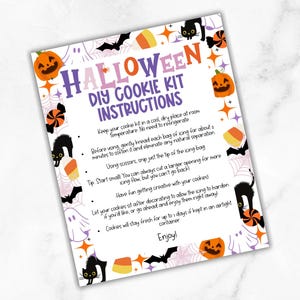 May include: A Halloween DIY cookie kit instructions sheet. The sheet has a white background with orange, purple, and black Halloween-themed graphics. The text reads "Halloween DIY Cookie Kit Instructions" with tips on how to use the kit.