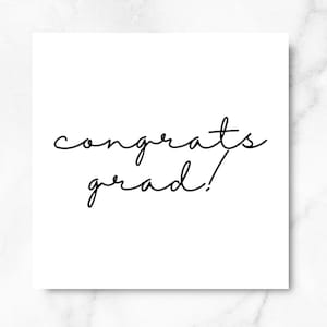 May include: A white card with black cursive text that reads "congrats grad!"