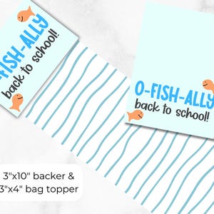 May include: Two light blue rectangular cards with the text "O-FISH-ALLY back to school!" and orange fish illustrations. One card is paired with a white and blue wavy patterned paper. The text "3"x10" backer & 3"x4" bag topper" is also present.