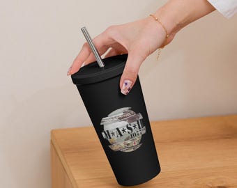 May include: Black reusable tumbler with a straw. The tumbler has a graphic of a globe with the text "M**A**S**H** 1027th" on it.