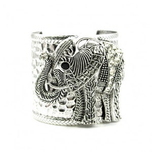 May include: Silver cuff bracelet with an ornate elephant design. The elephant is detailed with intricate patterns and has black eyes. The bracelet is decorated with small rhinestones.
