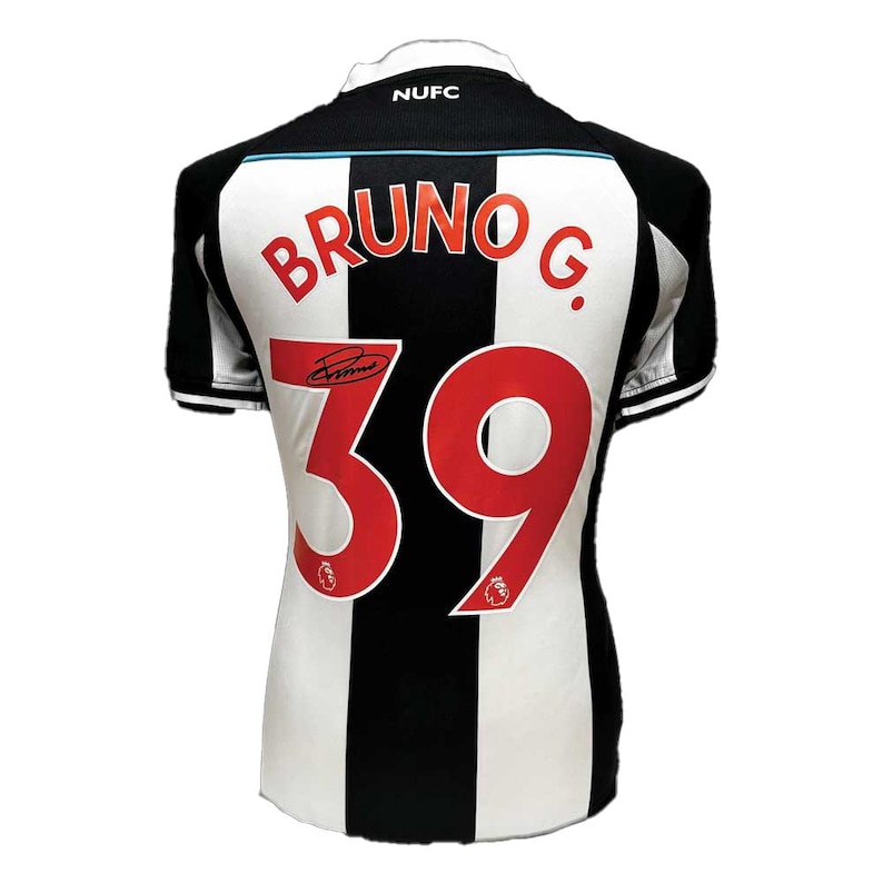 May include: A black and white striped soccer jersey with the name "BRUNO G." and the number "39" in red. The jersey has a "NUFC" logo on the collar and a signature. The jersey is a sports apparel item.