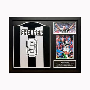 May include: A framed black and white soccer jersey with the name "Shearer" and the number "9" on the front. The jersey is signed by Alan Shearer. The frame includes two photos of Shearer playing soccer.