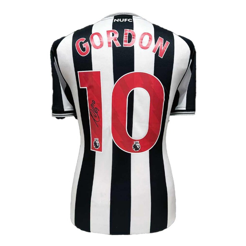 May include: A black and white striped jersey with the name "GORDON" in red letters above the number "10". The jersey has a signature and the "NUFC" logo on the collar.